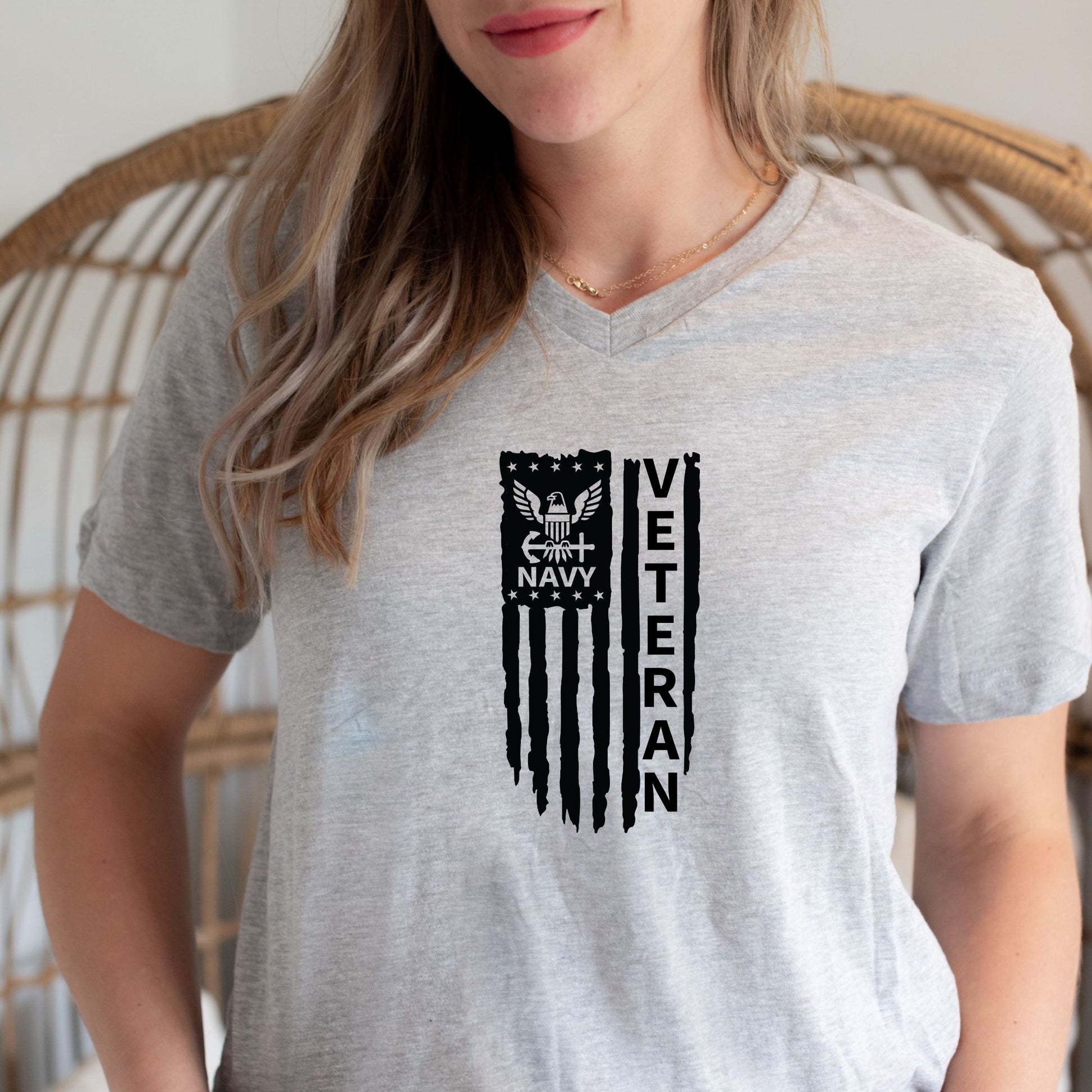 Rakkgear Women's Navy Veteran Grey V-Neck T-Shirt featuring a distressed vertical American Flag with 'Navy Veteran' inside, and the Rakkgear logo on the upper back.